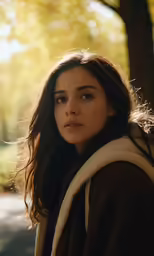 a woman is in the street and she looks into the distance