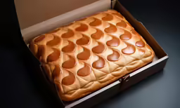 the box has a very small pattern of brown pizza