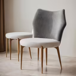 two chairs with wood legs and white cushions