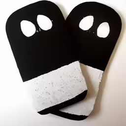 two black gloves with white dots and two eyes