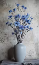 there is a white vase filled with blue flowers