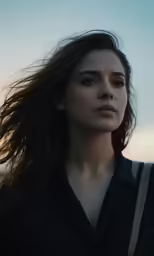a woman with her hair blowing in the wind