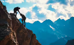 a couple of people standing on top of a tall mountain