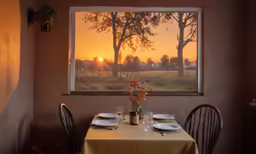 a dining room table is set with plates and place settings