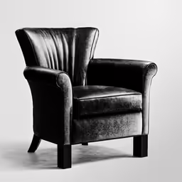 a black leather chair with wooden legs and armrests