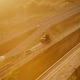 a vehicle driving down an over pass by highway