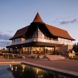 the large building has a pool and an outdoor dining area