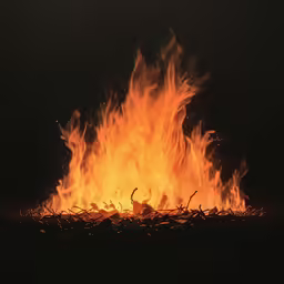 a huge blazing fire burning in the dark