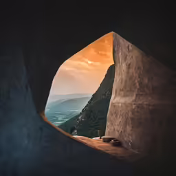 the view out a tunnel is over a body of water
