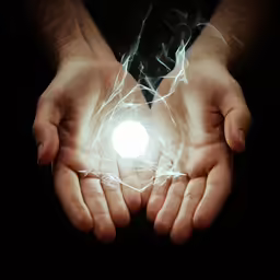 two hands with light glowing inside of them