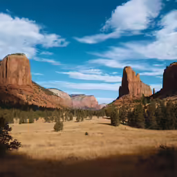a view of the valley with mountains in the background