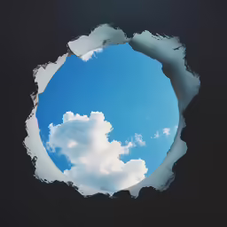 a round hole in the ground that shows a blue sky and clouds