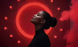 a beautiful black girl posing in front of a red and neon light