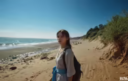 a woman standing on the beach in front of an ocean