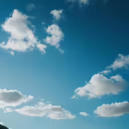 a clear blue sky with a star above