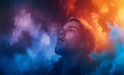 a man looking up with a bright light on the background
