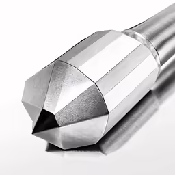 a close up of a metal tube on a white surface