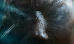 a man with a blue eye is shown in the rain