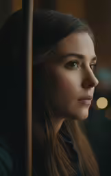 a woman standing in a bus with her eyes closed