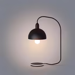 a black desk lamp on grey background with light bulb turned on