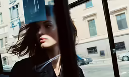 a woman looking out the window on the bus