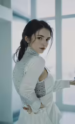 the woman is wearing white while holding her arm out