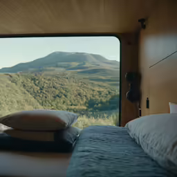 a view out the bedroom window looking at mountains