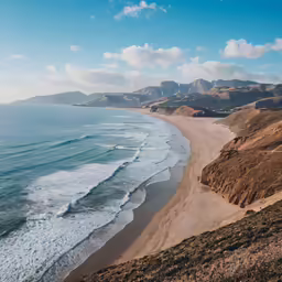a beach on top of a cliff near water