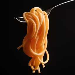 a fork in noodles that are dangling in the air