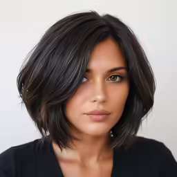 the girl with the brown shoulder length haircut looks into the camera
