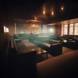 a large room with tables and couches under lights