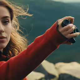 a young woman takes a picture with a camera