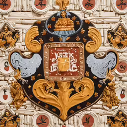 decorative art work of the crest of a wall with a clock