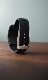a leather belt with gold accents on a wooden table