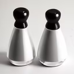 two white and black salt pepper shakers