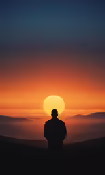 a person watching a sunset in the distance