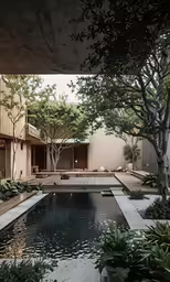 an exterior shot of an apartment building with a large backyard