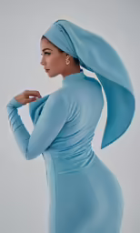 a woman with long hair wearing a blue dress