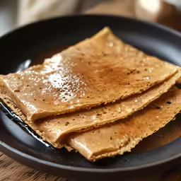 three pancakes with peanut butter and black sesame seeds