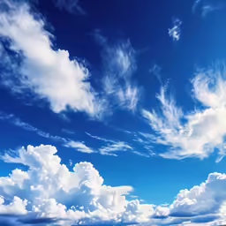 an airplane flying over an open grassy field on a clear day