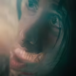 the woman has very large blue eyes and is looking at something