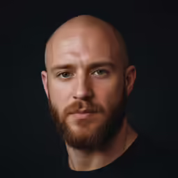 a man with a beard is looking to the side