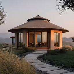 a round house sitting on top of a lush green field