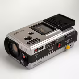 a compact camcorder sitting upright on a table