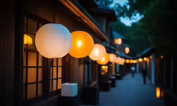 the lanterns are glowing on the side of a house