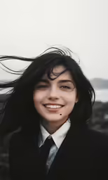 a person that has long hair and a smile