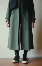 the woman wears black high top sneakers and a green coat