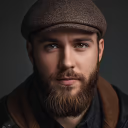 a man with a very well beard looks at the camera