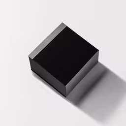 a black cube with a silver edge on a white background