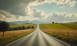 a deserted road is shown during a partly cloudy day